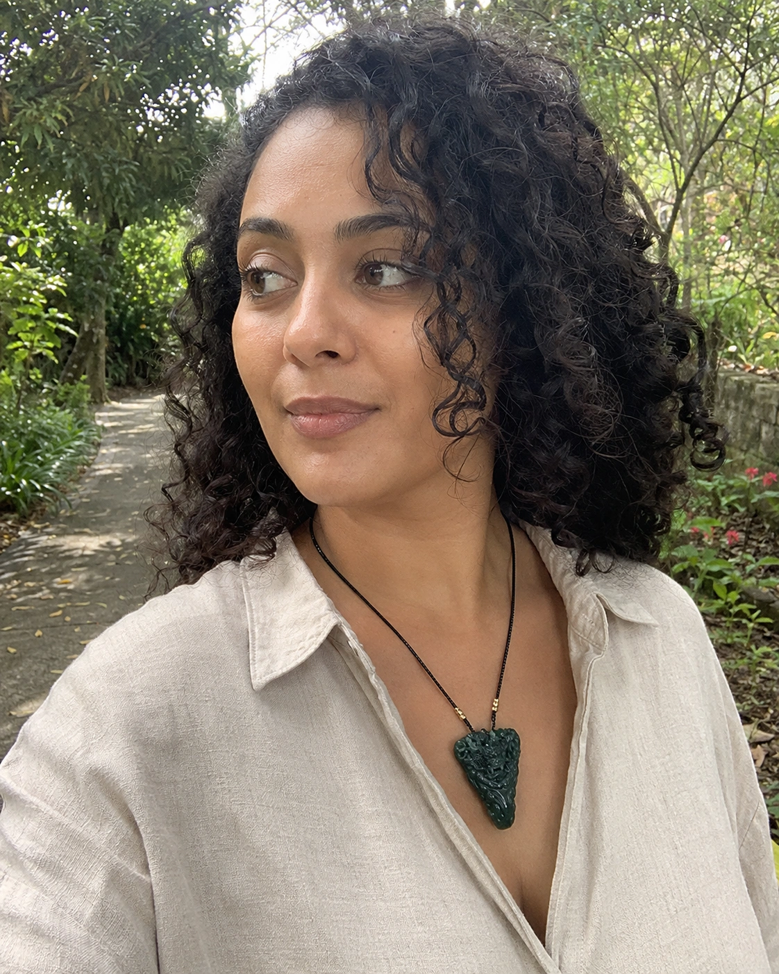 Carved green pendant worn outdoors